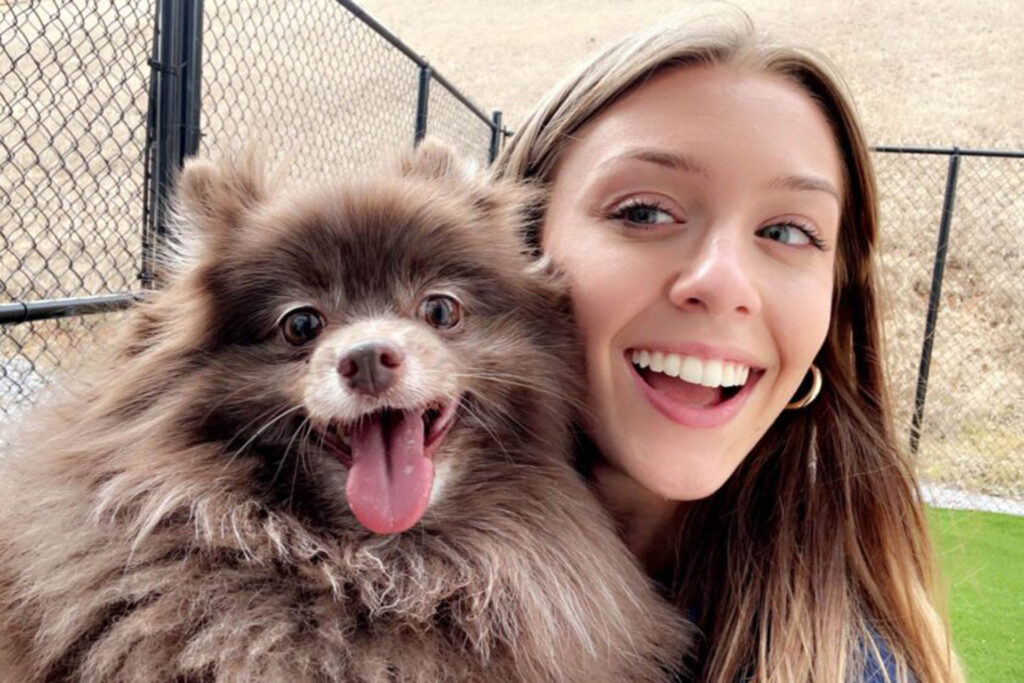 Woman smiling with her dog.