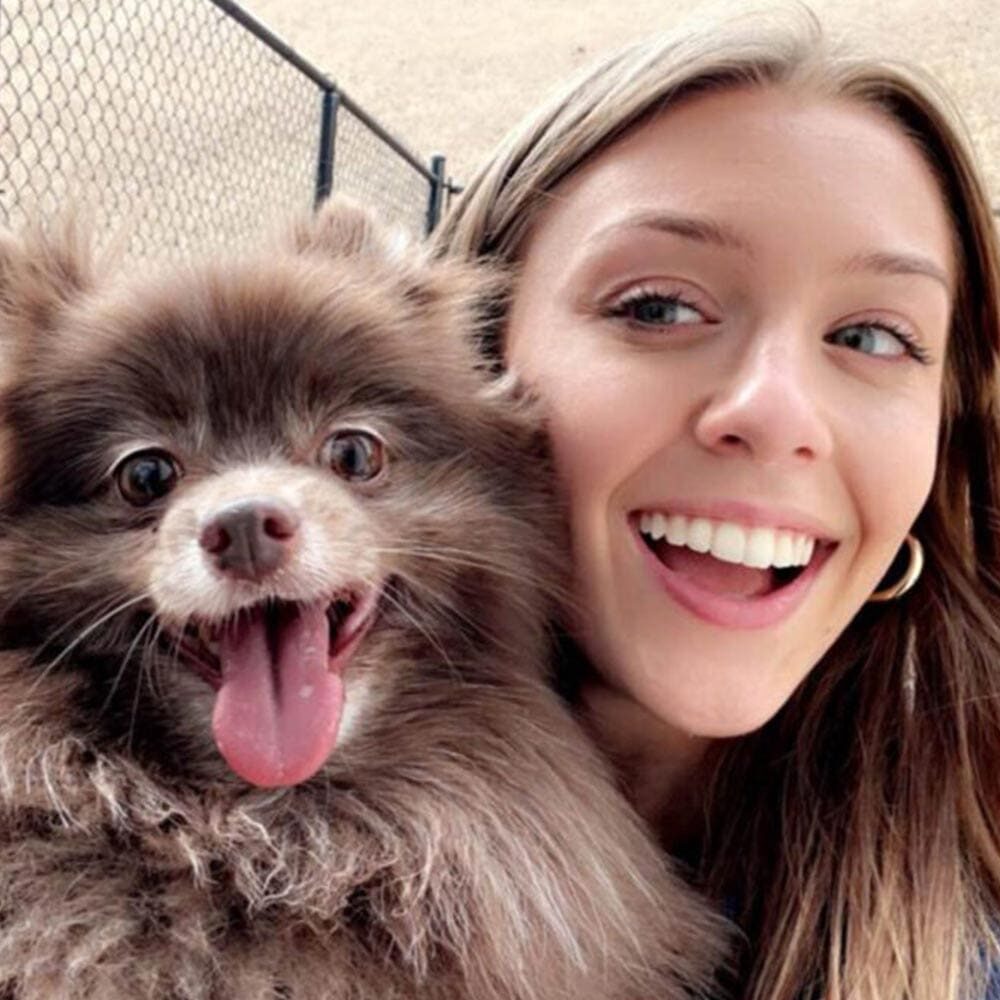 Staff Member Smiling With Happy Dog